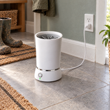 PackPaws paw washer charging over its USB cable